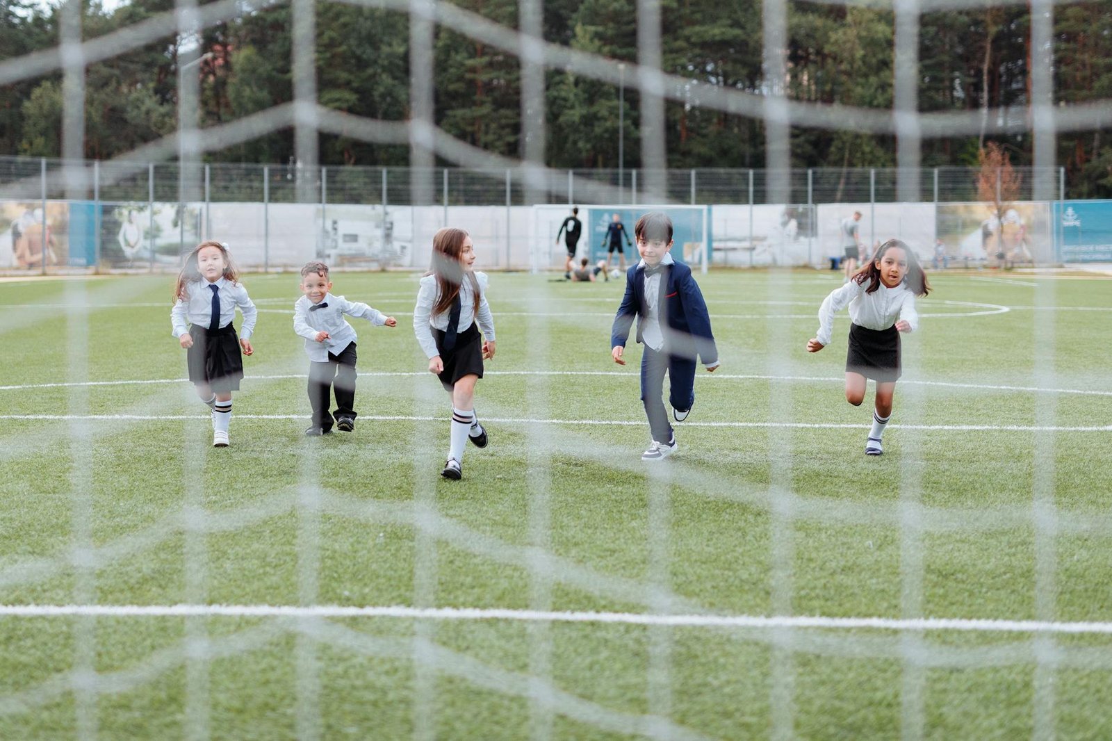 Children in uniforms playing team soccer